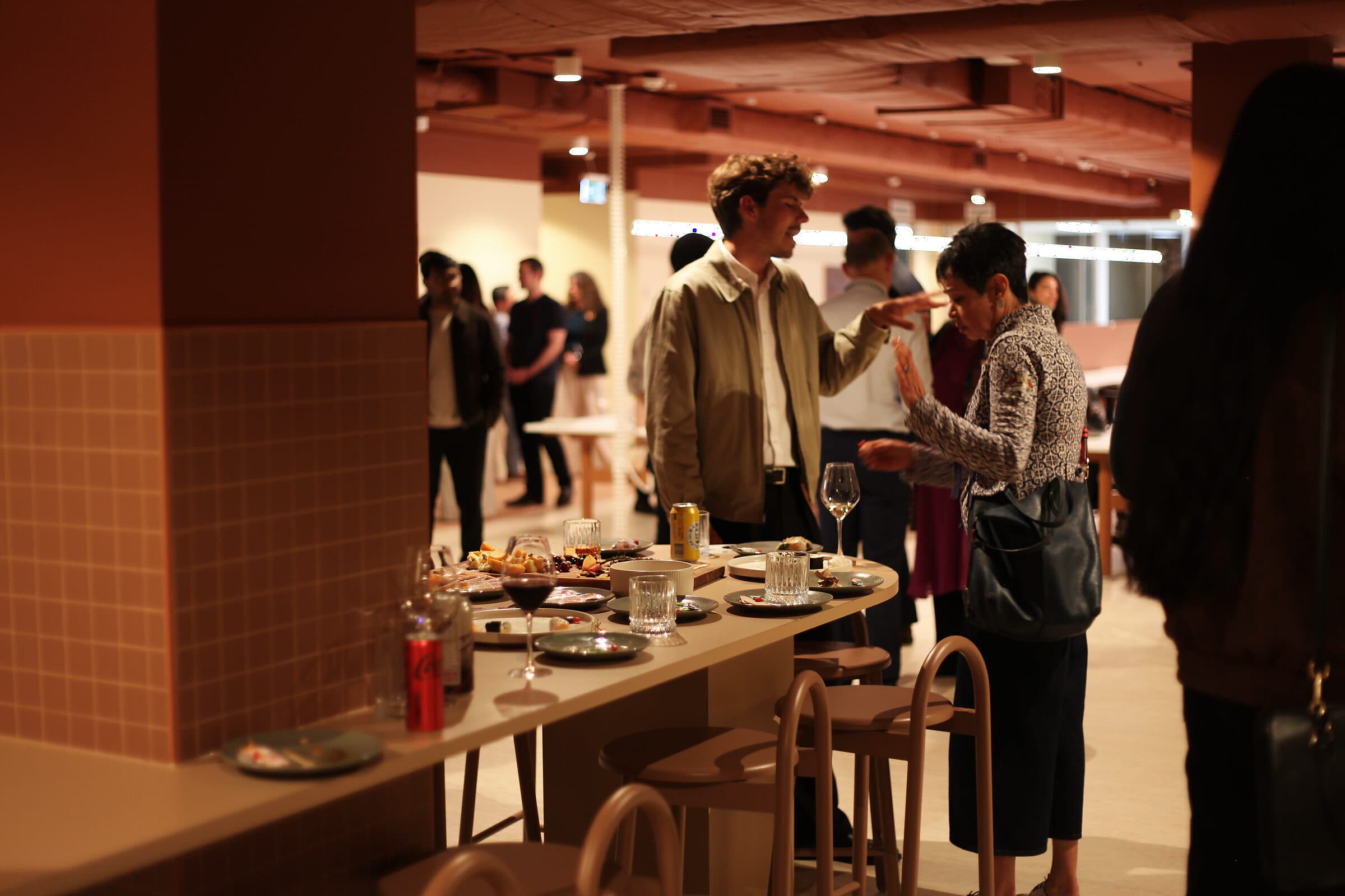 People talking over food at the Workspace bar