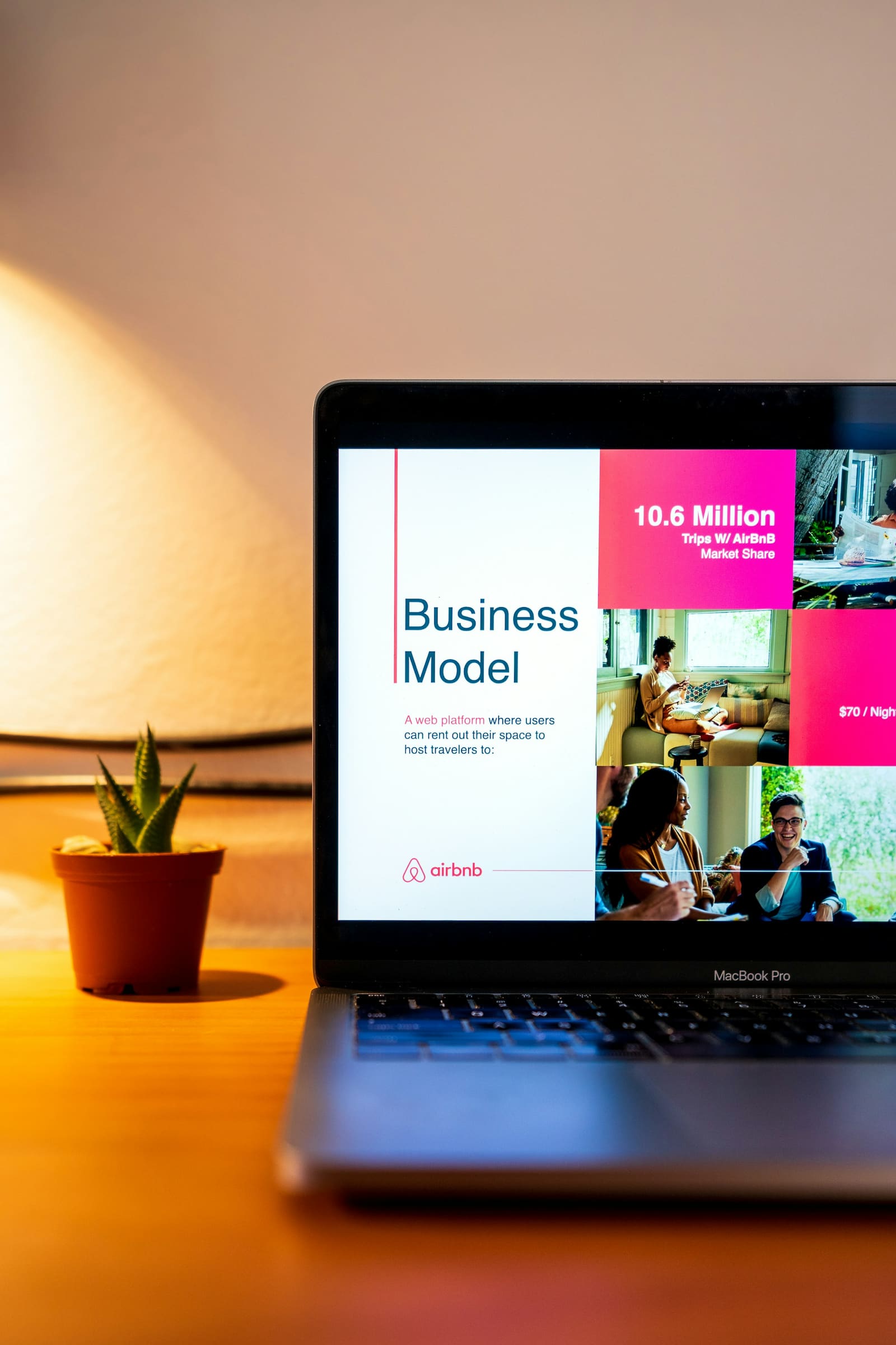 A laptop displaying a startup business model presentation